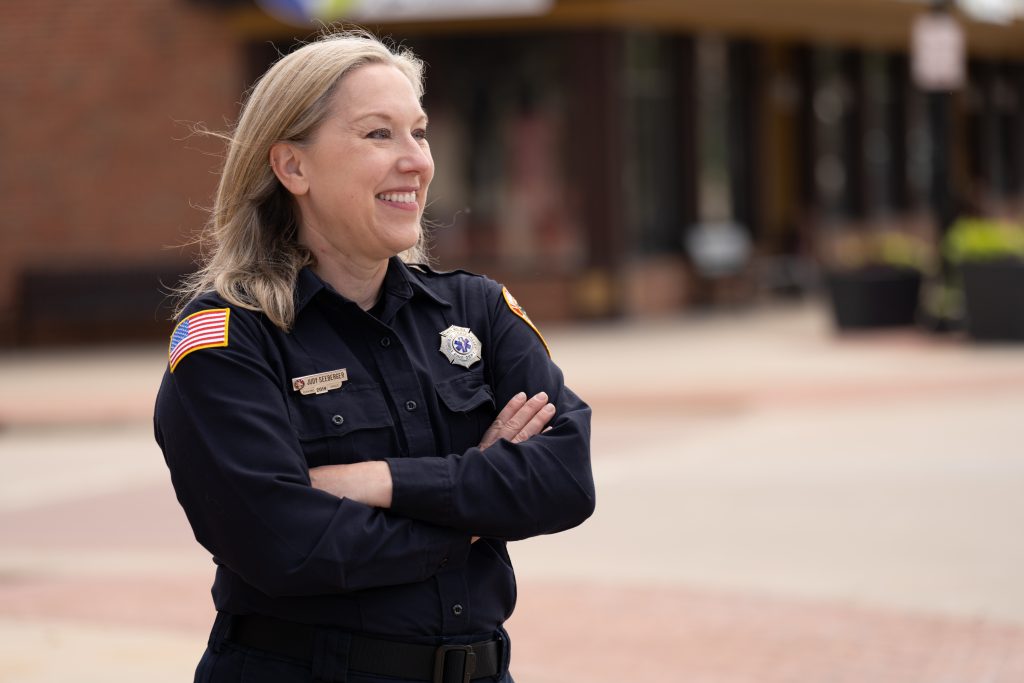 Picture of Judy in paramedic uniform standing in plaza